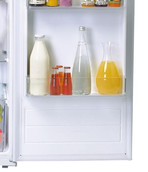 Balconnet inférieur du Candy CIO 225 EE/NCM, avec bouteille de lait, boisson gazeuse et carafe de jus d'orange.